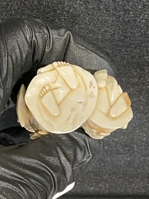 Lot 56 - A small Japanese carved and stained  ivory group, probably early 20th Century