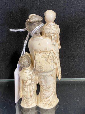 Lot 56 - A small Japanese carved and stained  ivory group, probably early 20th Century