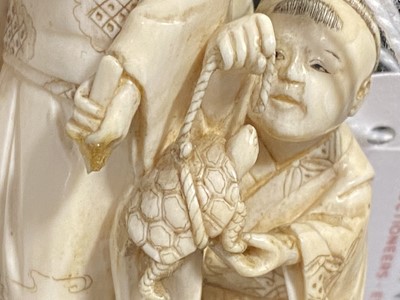 Lot 56 - A small Japanese carved and stained  ivory group, probably early 20th Century
