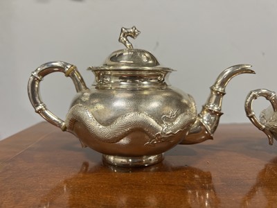 Lot 45 - Chinese silver three piece teaset with sugar tongs and a rosewood tray
