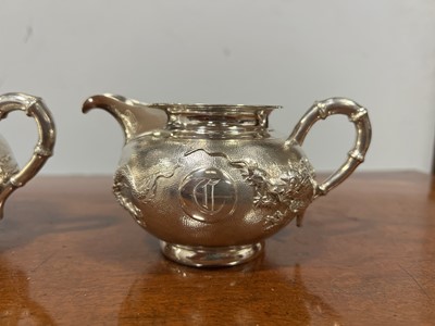 Lot 45 - Chinese silver three piece teaset with sugar tongs and a rosewood tray