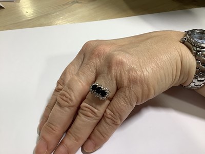 Lot 50 - A sapphire and diamond triple cluster ring.