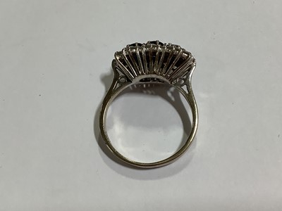 Lot 50 - A sapphire and diamond triple cluster ring.
