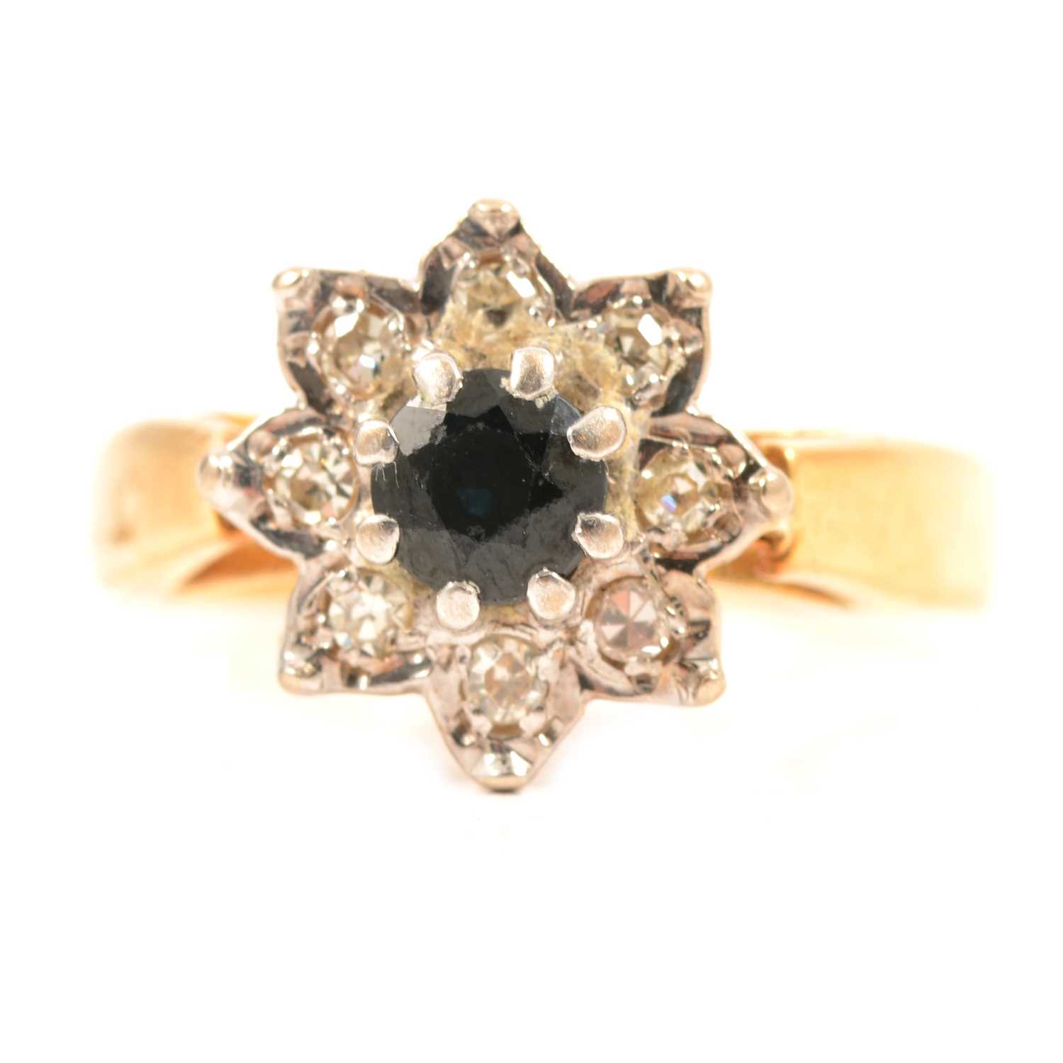 Lot 51 - A sapphire and diamond cluster ring.
