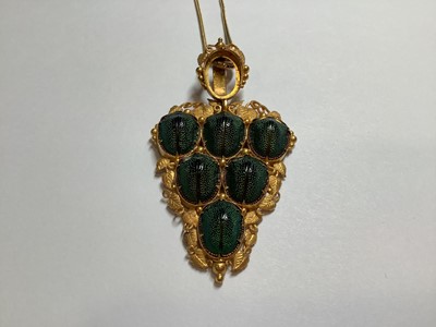 Lot 229 - A yellow metal scarab style pendant on a foxtail link chain.