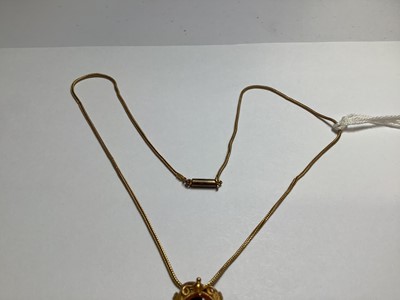 Lot 229 - A yellow metal scarab style pendant on a foxtail link chain.
