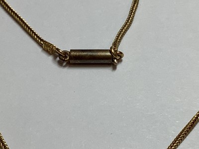 Lot 229 - A yellow metal scarab style pendant on a foxtail link chain.