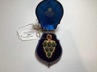 Lot 229 - A yellow metal scarab style pendant on a foxtail link chain.