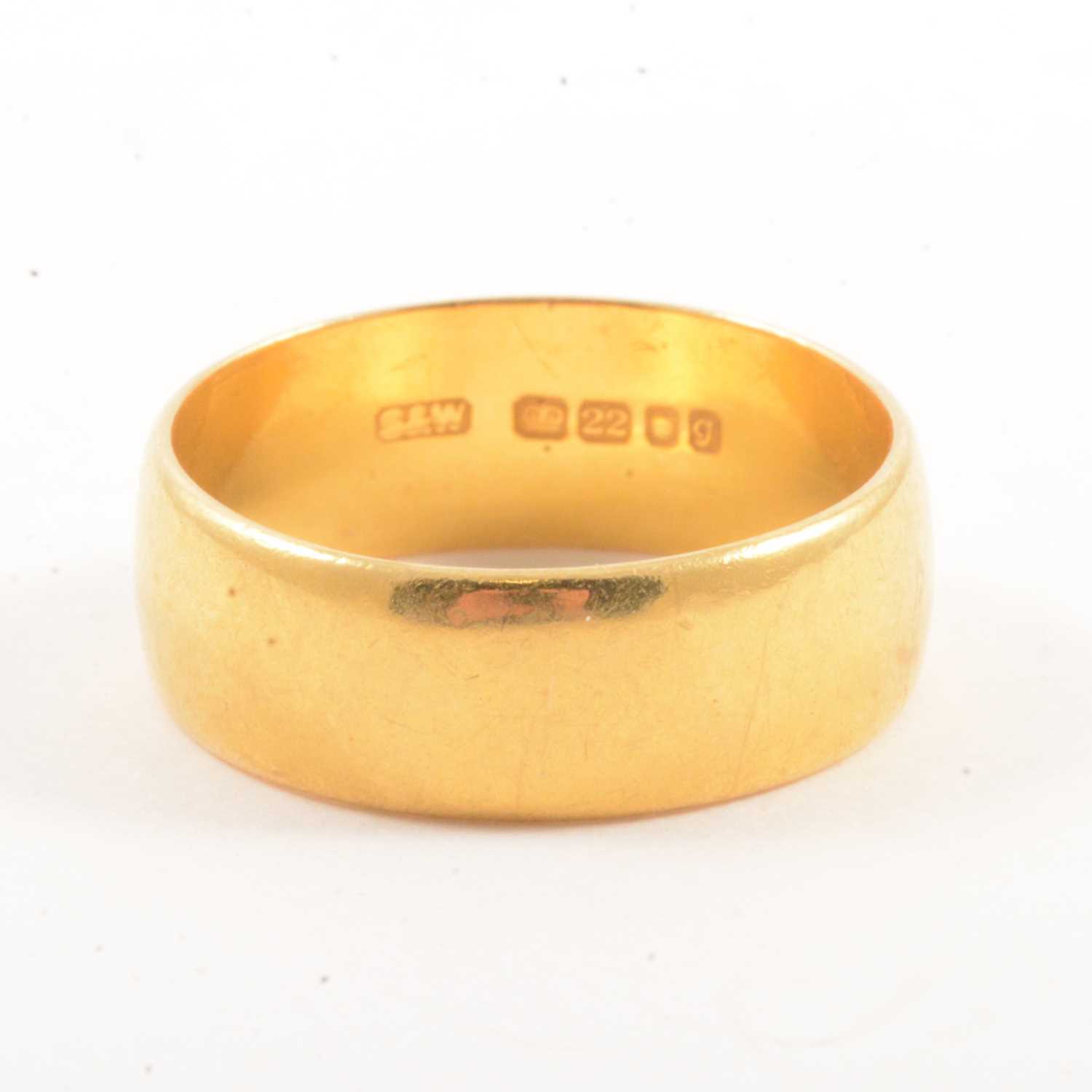 Lot 105 - A 22 carat yellow gold wedding band.