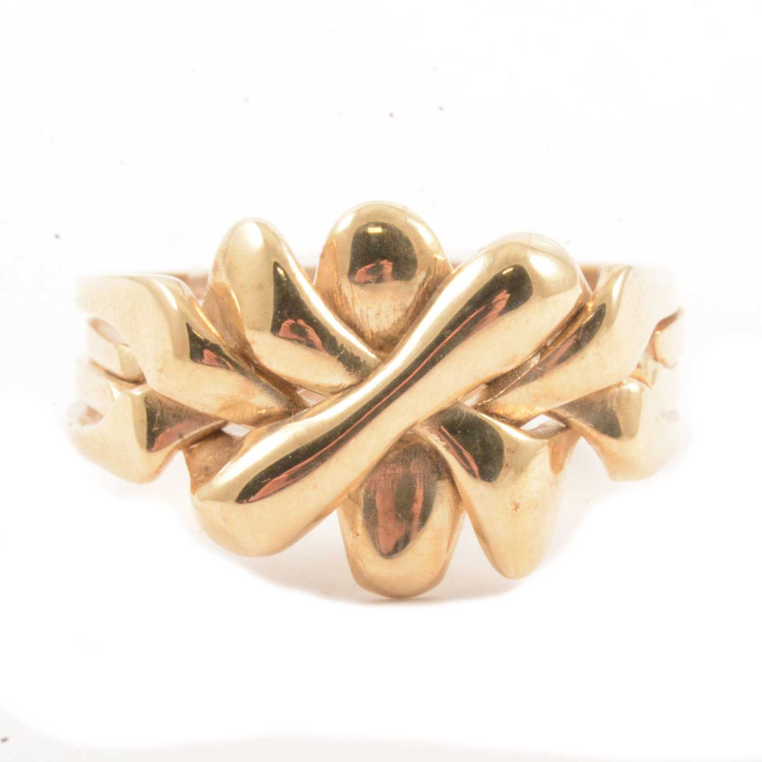 Lot 97 - A 9 carat yellow gold puzzle ring.
