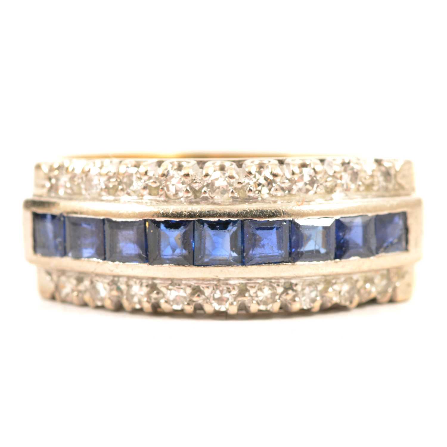 Lot 19 - A sapphire and diamond half hoop ring.