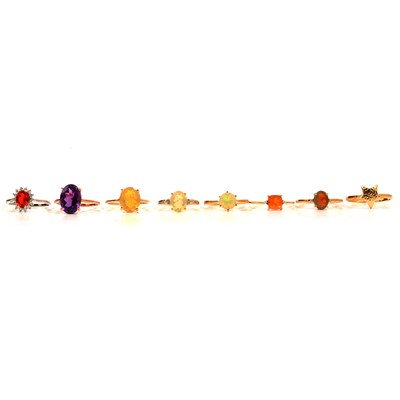 Lot 51 - Eight gold rings, Ethiopian opal, fire opal and others.
