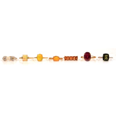 Lot 58 - Seven gemset gold rings, garnet, moldavite, Coober Pedy opal, Ehtiopian opal and others.