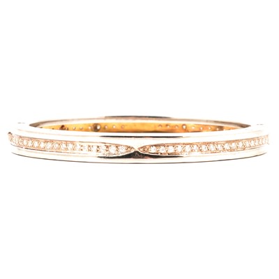Lot 244 - Bvlgari - A b.zero1 steel and gold bangle aftermarket set with diamonds.