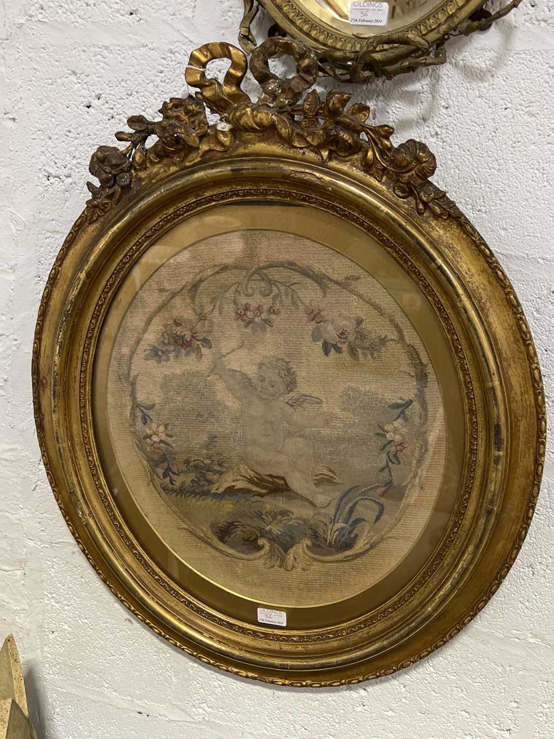 Lot 36 - Early 19th century needlework panel in a gilt frame, mirror, and a brass and onyx candelabra