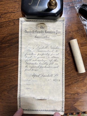 Lot 62 - Dunhill Namiki fountain pen on square form desk stand, with paperwork